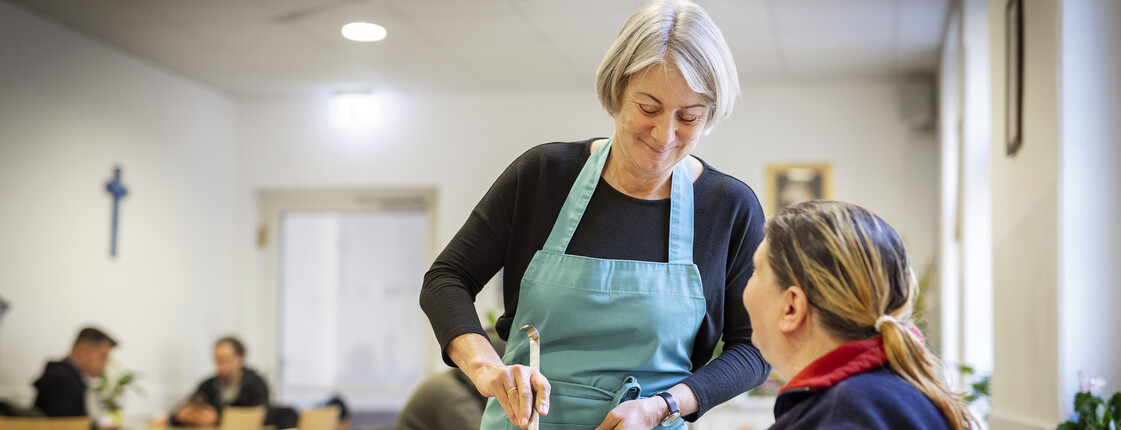 Eine Freiwillige gibt im Marienstüberl Suppe aus